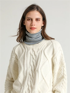 Detail of blue and white striped knitted turtleneck neck warmer with cable knit texture
