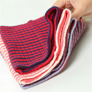 Vertical layers of striped knitted winter neck gaiters showing elastic ribbed texture
