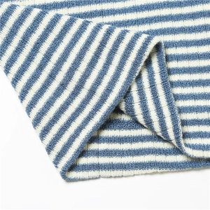 Close-up of blue and white striped knitted fabric texture with ribbed pattern details