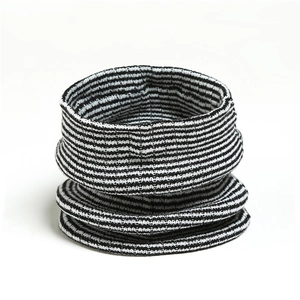 Detail of black and white striped knit neck warmer showing premium yarn texture