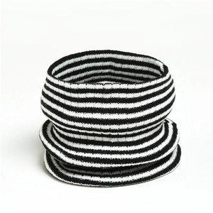 Striped knitted neck warmer with black and white horizontal ribs for winter warmth