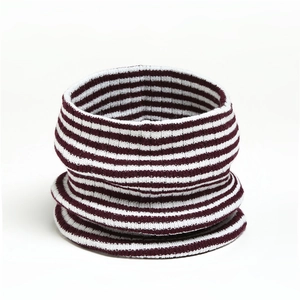 Detailed view of striped knit neck warmer in deep red and white soft textured fabric