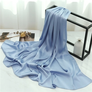 Close-up of light blue pleated scarf draped on a modern iron stand for home decor