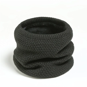 Close-up of thick black knitted neck warmer showing honeycombed texture and fleece lining
