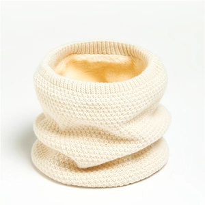 Detail of cream knit neck warmer showing thick waffle texture and soft fleece lining