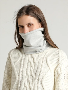 Close-up of soft light grey cotton neck warmer knitted fabric texture on model