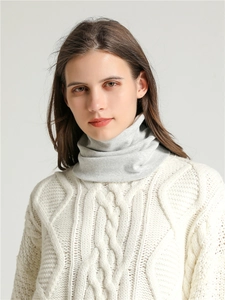 Close-up of light grey soft cotton neck warmer styled with a white cable knit sweater