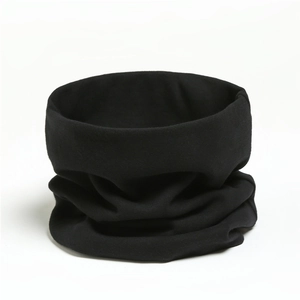 Close-up of soft black cotton neck gaiter showing premium knitted texture and fabric folds