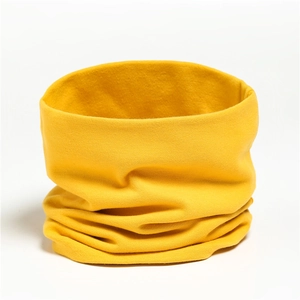 Close-up of soft ginger yellow knitted cotton neck warmer with fine ribbed texture