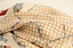Macro detail of luxury silk scarf showing glossy satin texture and retro horse carriage print