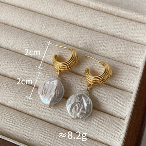 Detailed view of baroque freshwater pearl earrings with 2cm gold-plated hooks