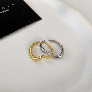 Minimalist double layer wavy open rings in gold and silver finish on display