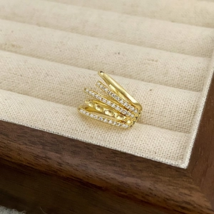 Detail of gold double-layer ear cuff featuring sparkling pavé cubic zirconia settings