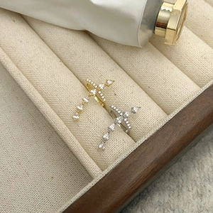 Cross zircon adjustable rings in gold and silver finish displayed on velvet tray