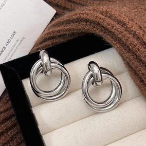 Minimalist silver triple interlocking hoop earrings displayed in a gift box