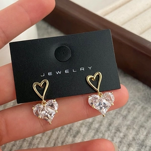 Elegant gold hollow heart earrings with large sparkling heart-shaped zircon pendants