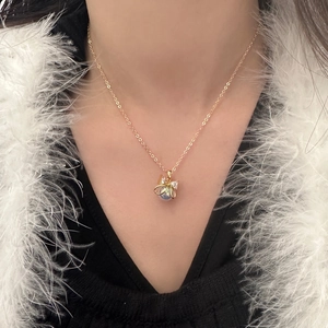 Elegant gold butterfly necklace with mermaid pearl and zircon on model's neckline