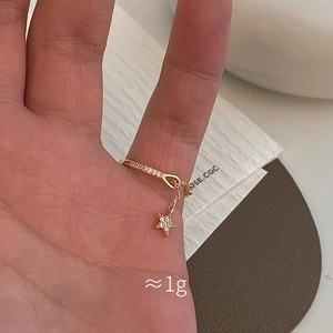 Star zircon chain ring in gold finish with dangling star charm and sparkling stones