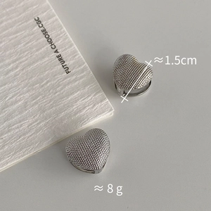 Detailed view of silver heart earrings with textured finish measuring 1.5cm and weighing 8g