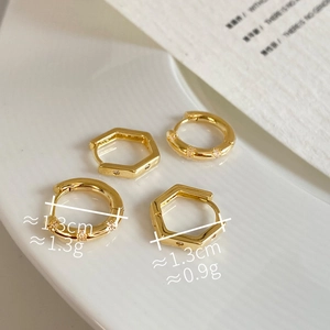 Macro detail of 1.3cm gold geometric hoop earrings with micro-pave cubic zirconia
