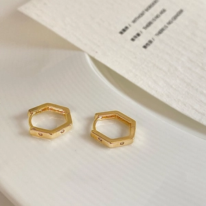 Detail shot of gold-plated hexagonal hoop earrings featuring micro-pave zircon stones