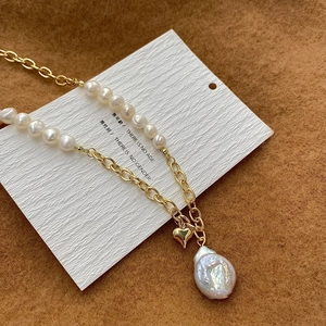 Detail of freshwater pearl necklace with heart pendant and baroque pearl on display