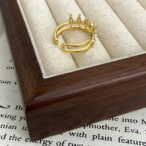 Elegant gold crown open ring with white pearls and zircon on a luxury velvet jewelry box