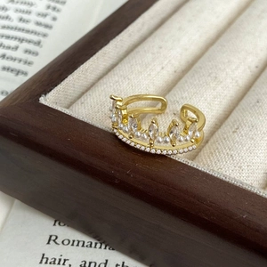 Detailed shot of crown ring with marquise zircon and pearls on wooden jewelry display