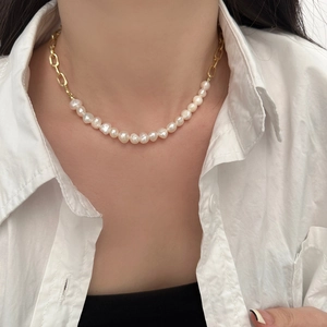 Baroque irregular freshwater pearl and gold paperclip link necklace on a white shirt