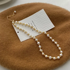 Detailed view of French baroque natural freshwater pearl necklace with golden accent beads