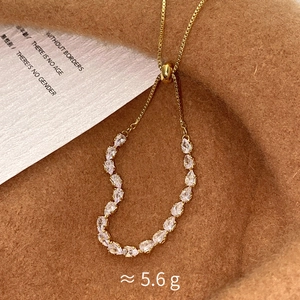 Detail of heart pendant with pear-cut cubic zirconia on golden box chain weight 5.6g