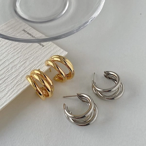 Triple layered C-shape hoop earrings in polished gold and silver metallic finishes