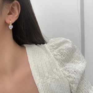 Sparkling heart crystal earrings with gold plated hoops shown on female model
