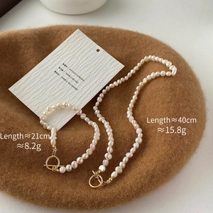 Baroque freshwater pearl necklace and bracelet set with golden OT toggle clasp on wool hat