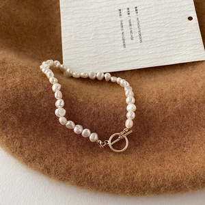 Baroque freshwater pearl bracelet with golden toggle clasp on elegant autumn background