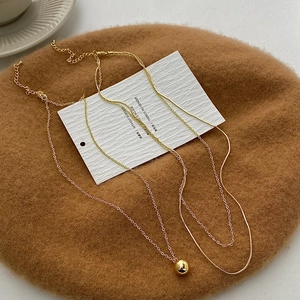 Minimalist gold-plated double-layer necklace with round ball pendant and flat snake chain