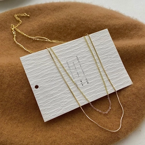 Close-up of double-layered gold-plated snake chain necklace with an adjustable clasp