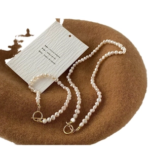 Baroque freshwater pearl necklace and bracelet set with golden OT toggle on brown wool beret
