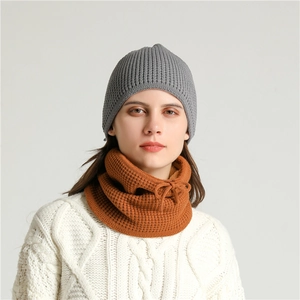 Close-up of grey ribbed knit beanie and ginger waffle neck warmer with drawstring detail