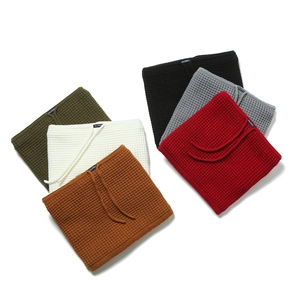 Macro shot of waffle-knit neck warmer textures in six colors with drawstring details