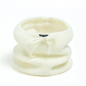 Detailed view of cream-white knitted neck warmer with plush lining and drawstring detail