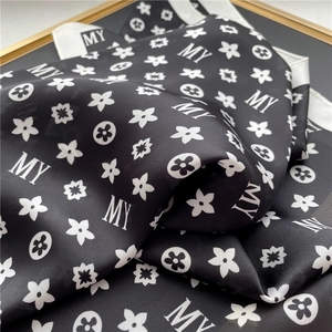 Elegant black and white floral silk scarf with monogram print and satin texture finish