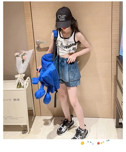 Détail d'un ensemble d'été pour fille avec débardeur blanc et jupe en jean tendance