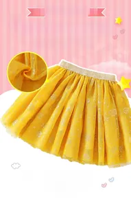 Detail of yellow tulle skirt showing golden elastic waistband and glitter rose patterns