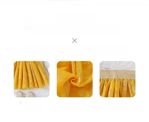 Detail of yellow tulle girls' skirt with 3D sequins and golden elastic waistband
