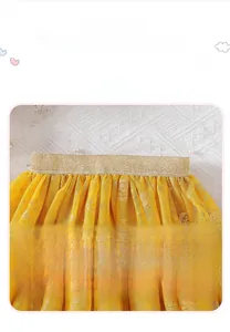 Detail of yellow tulle tutu skirt for girls with gold sequins and elastic waistband