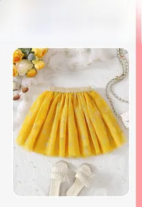Flat lay of yellow girls' tulle skirt with gold glitter waistband and rose floral patterns