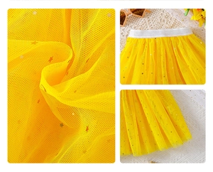 Detailed close-up of yellow tutu skirt showing sparkling gold star sequins and mesh layers