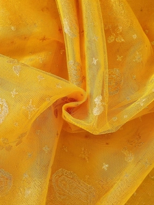 Yellow girls' tutu skirt made of sheer mesh with shimmering star and floral prints