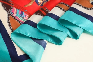 Detailed view of satin scarf showing intricate chain patterns and glossy fabric texture